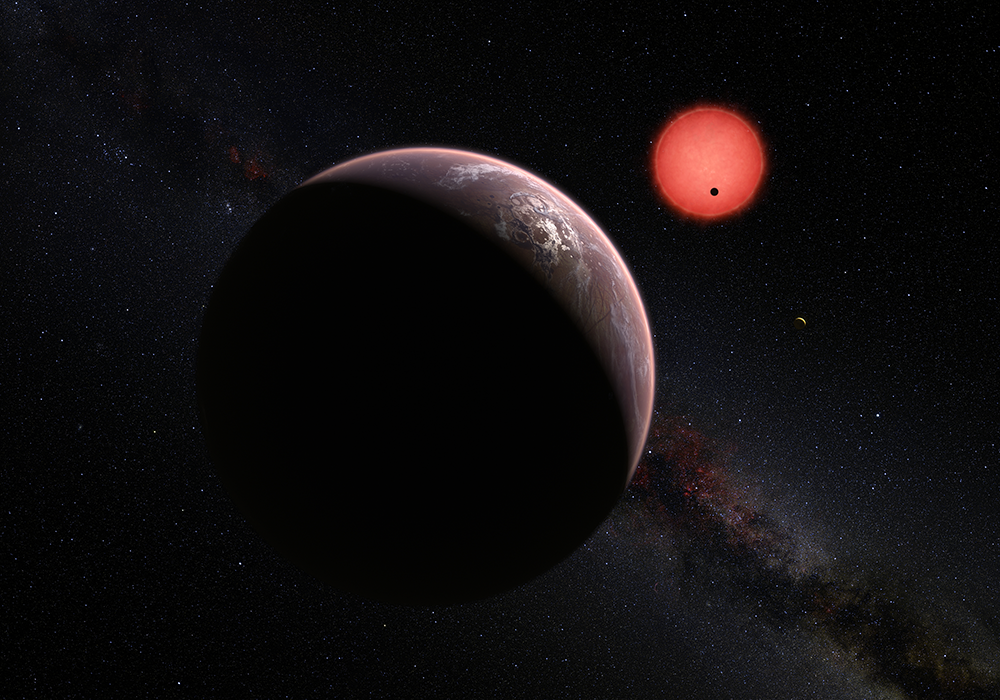 This artist’s impression shows an imagined view of the three planets orbiting an ultracool dwarf star just 40 light-years from Earth that were discovered using the TRAPPIST telescope at ESO’s La Silla Observatory. These worlds have sizes and temperatures similar to those of Venus and Earth and may be the best targets found so far for the search for life outside the Solar System. They are the first planets ever discovered around such a tiny and dim star. In this view one of the inner planets is seen in transit across the disc of its tiny and dim parent star. (Credit: ESO/M. Kornmesser/N. Risinger (skysurvey.org))